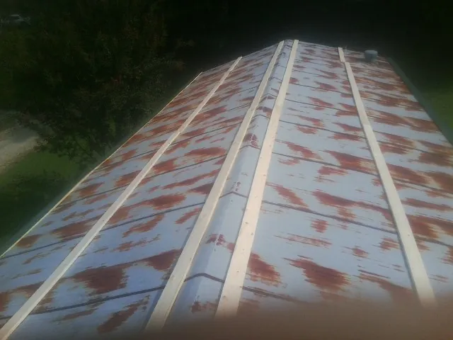 Rusted metal roof panels with new wood purlins before replacement — Storm Damage Roof Repair in Mitchell by Roofing Brothers