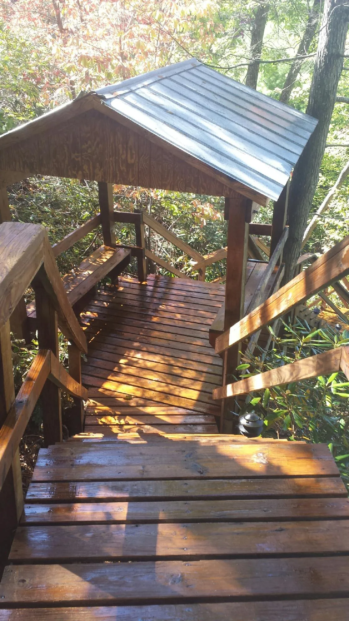 Freshly stained wood walkway and covered shelter with a metal roof in Mitchell